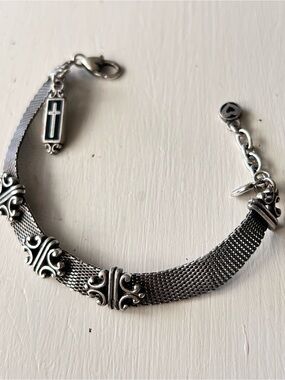 Brighton silver mesh bracelet with decorative filigree links and a cross charm